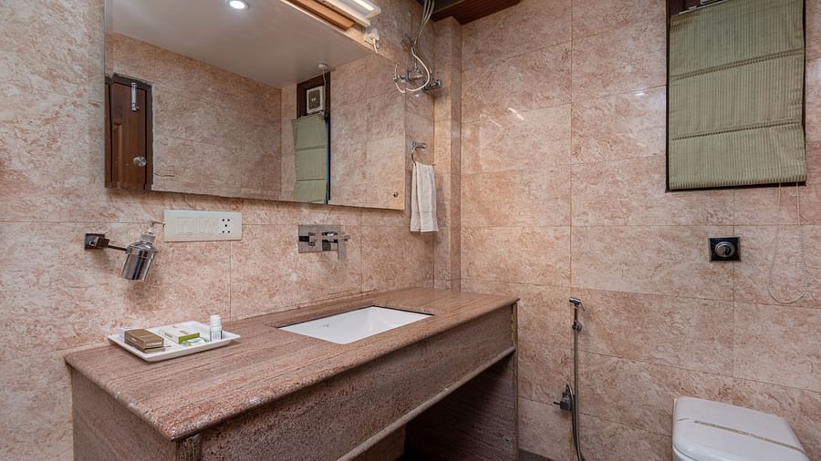 Washroom of the deluxe room featuring premium toiletries and a sleek wash basin.